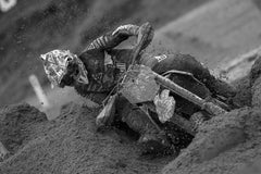 Motocross Rider racing through mud