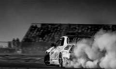 Race Car drifting and kicking up dust
